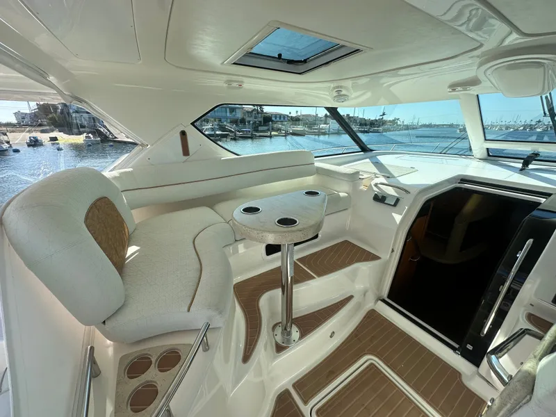 Slide: The Image of Luxurious 2006 Tiara Yachts Sovran interior with elegant seating and scenic marina view. - 25