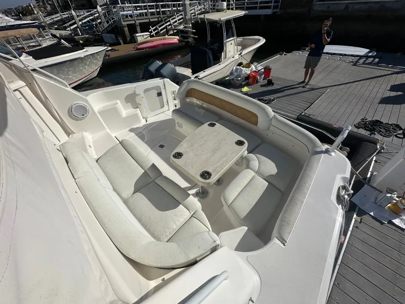 Slide: The Image of 2006 Tiara Yachts Sovran boat interior with cushioned seating and table at dock. - 26