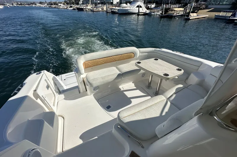 Slide: The Image of 2006 Tiara Yachts Sovran with spacious seating and table on deck, cruising in marina. - 28