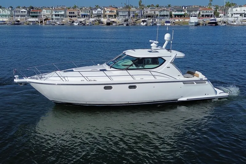 Slide: The Image of 2006 Tiara Yachts Sovran cruising on calm waters near a marina. - 3