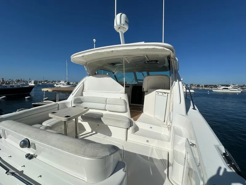 Slide: The Image of 2006 Tiara Yachts Sovran with spacious seating, docked in a serene marina setting. - 36