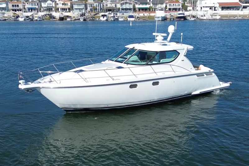 Slide: The Image of 2006 Tiara Yachts Sovran cruising on calm waters near a marina. - 39