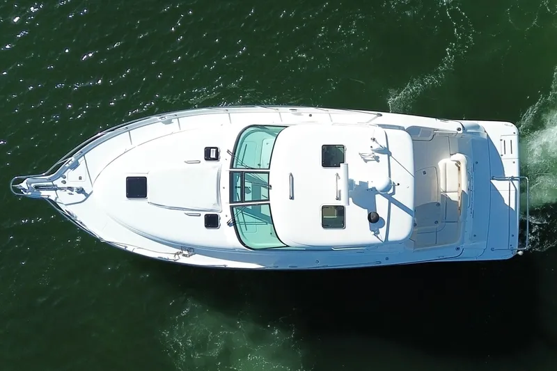 Slide: The Image of Aerial view of 2006 Tiara Yachts Sovran cruising on green water. - 4