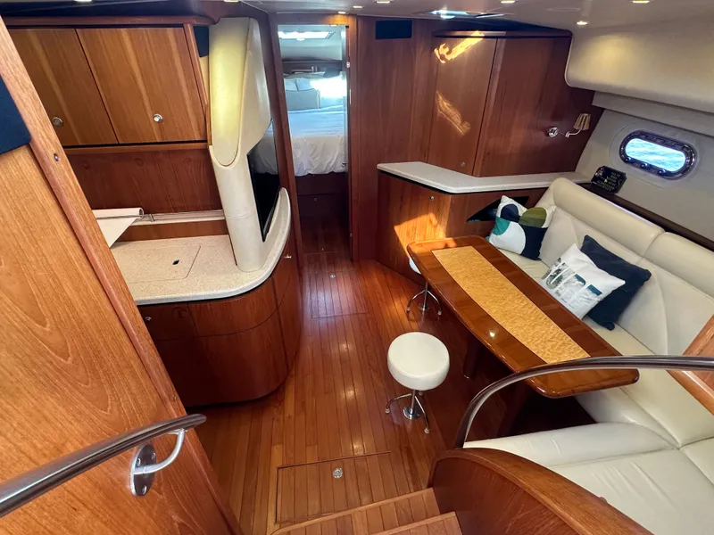 Slide: The Image of 2006 Tiara Yachts Sovran interior with wood finish, seating area, and modern amenities. - 5