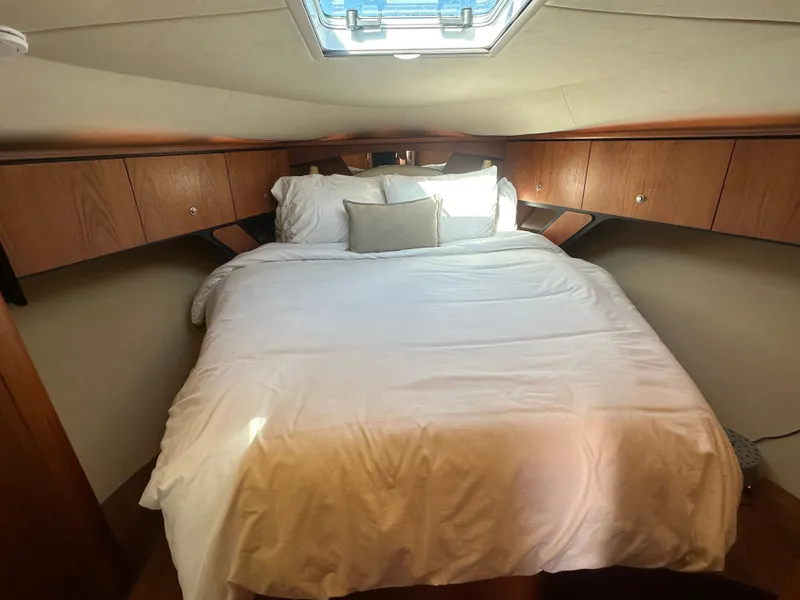 Slide: The Image of Luxurious cabin interior of 2006 Tiara Yachts Sovran with cozy bed and wooden cabinetry. - 8