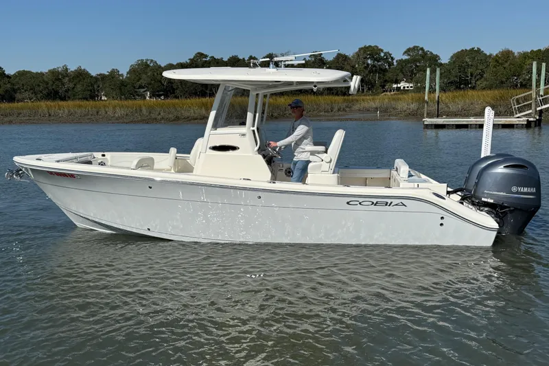 Slide: The Image of 2023 Cobia 240CC boat with Yamaha engine on calm water. - 11