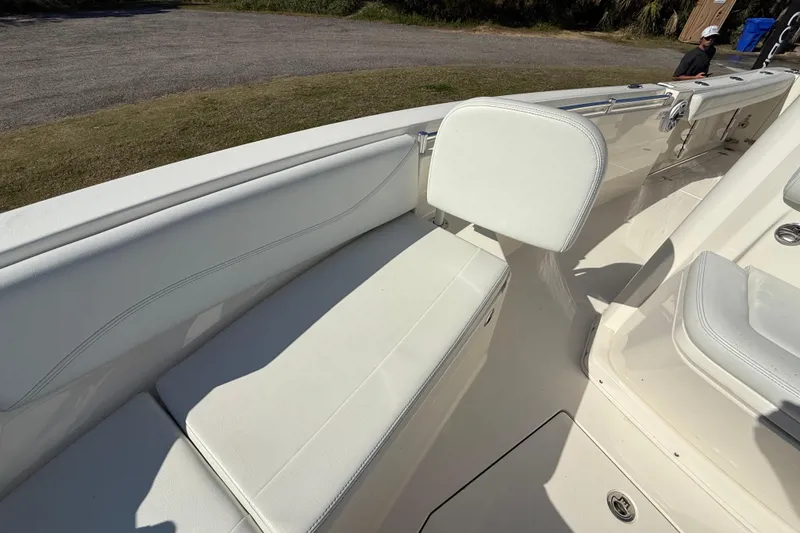 Slide: The Image of 2023 Cobia 240CC boat interior with white seating and deck details. - 25