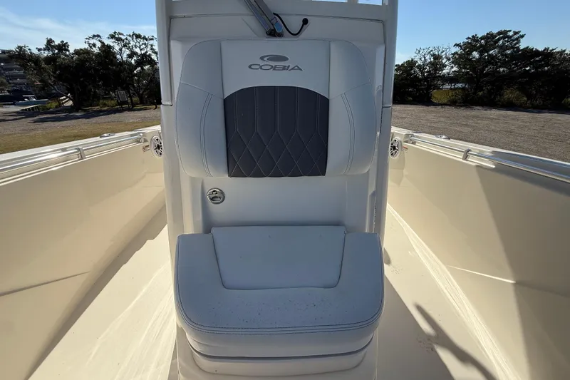 Slide: The Image of 2023 Cobia 240CC boat seat with logo, outdoor setting, clear sky. - 27