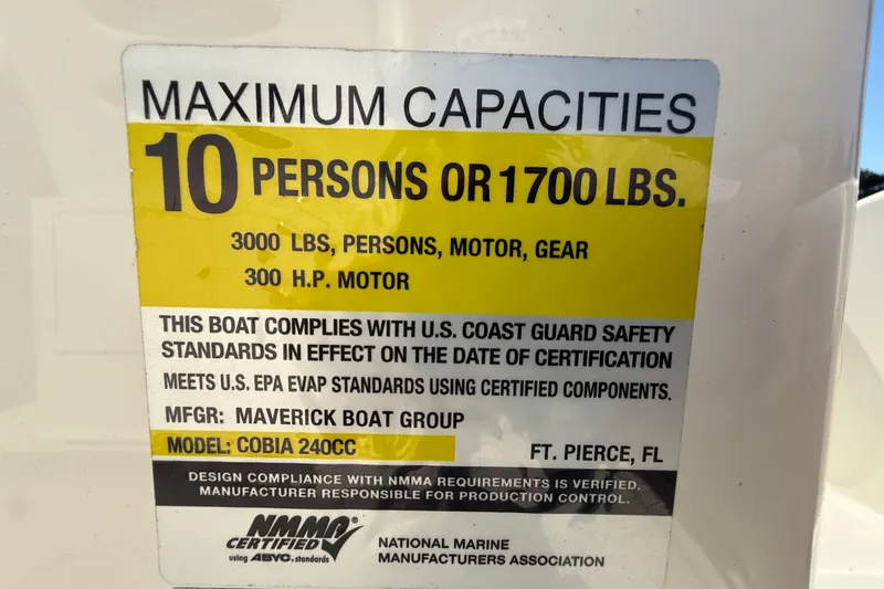 Slide: The Image of 2023 Cobia 240CC boat capacity label: 10 persons, 1700 lbs, 300 HP motor. - 37