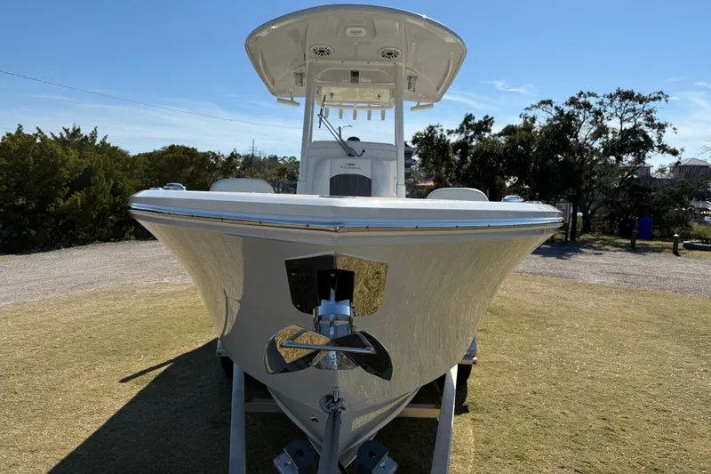 Slide: The Image of 2023 Cobia 240CC boat on trailer, front view, outdoors on grass. - 4