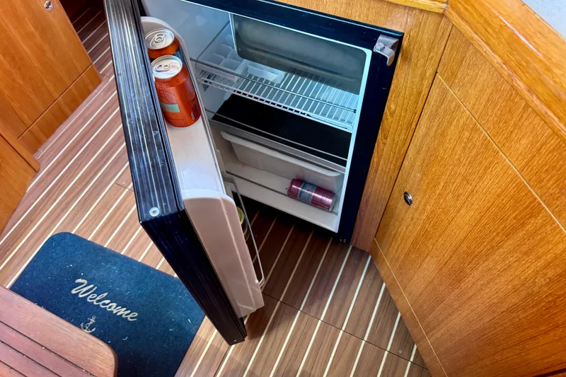 Slide: The Image of Open mini fridge on 2003 Hunter 36 yacht with drinks inside. - 11