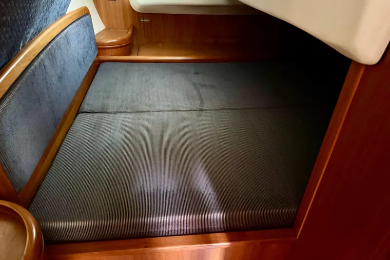 Slide: The Image of Interior cabin of 2003 Hunter 36 sailboat with cushioned seating area. - 15