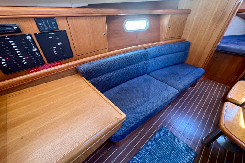 Slide: The Image of Interior of 2003 Hunter 36 sailboat with blue sofa and wooden cabinetry. - 7