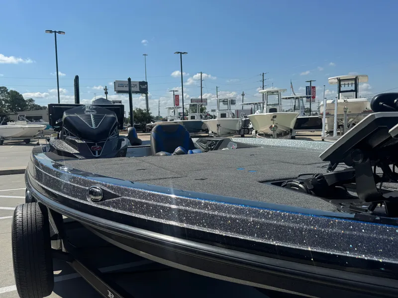 Slide: The Image of 2019 Ranger Z520L boat in a dealership lot under a clear blue sky. - 14