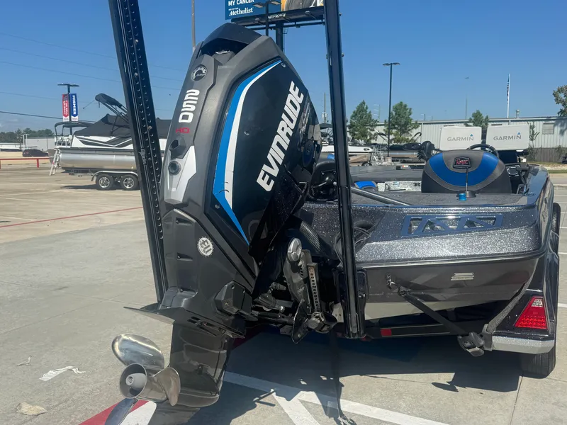 Slide: The Image of 2019 Ranger Z520L boat with Evinrude engine, parked outdoors on a sunny day. - 6