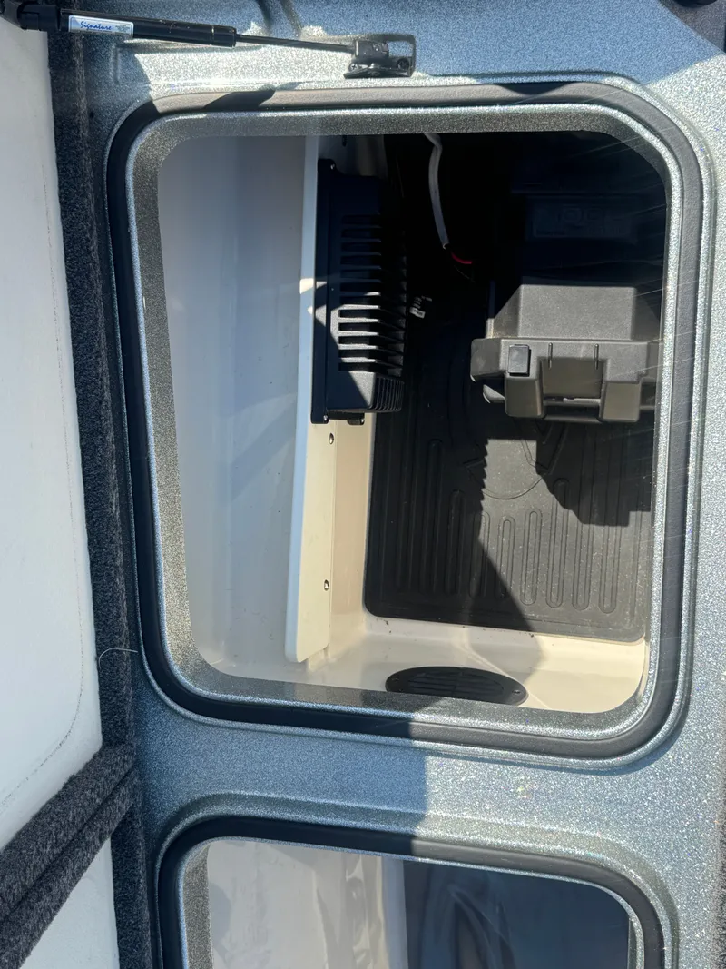 Slide: The Image of 2019 Ranger Z520L boat storage compartment with battery and wiring. - 21