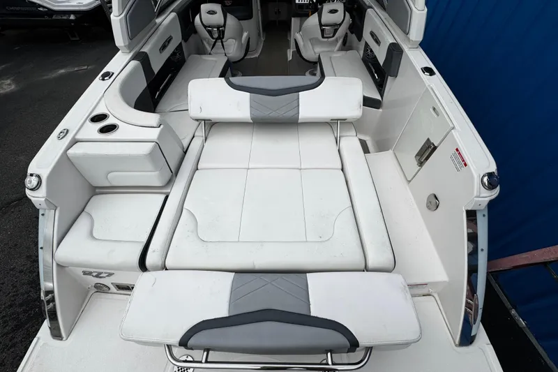 Slide: The Image of 2020 Chaparral 277 SSX boat interior with white seating and cup holders. - 10
