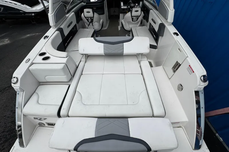 Slide: The Image of 2020 Chaparral 277 SSX boat interior with white seating and modern dashboard. - 11