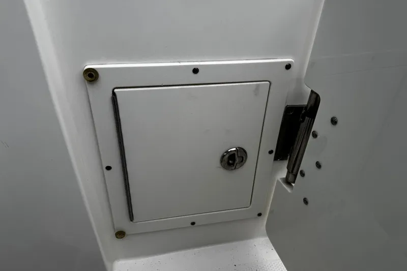 Slide: The Image of 2020 Chaparral 277 SSX boat storage compartment with secure lock. - 14
