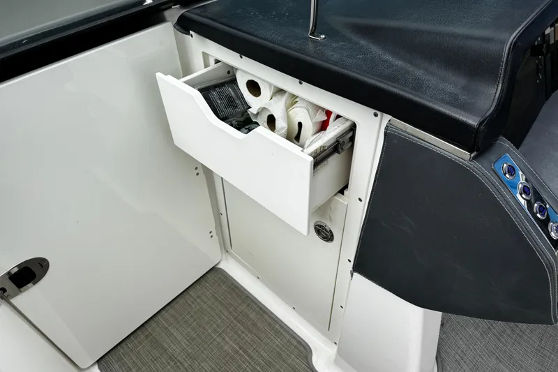 Slide: The Image of 2020 Chaparral 277 SSX boat interior with open storage drawer containing supplies. - 29