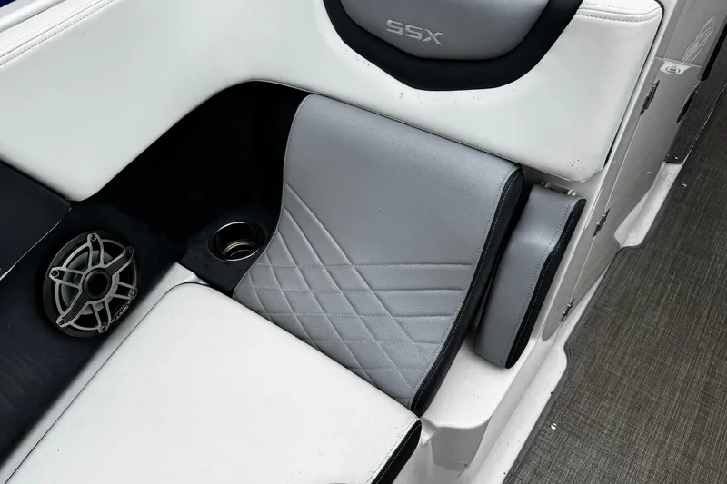 Slide: The Image of 2020 Chaparral 277 SSX boat interior with gray seating, speaker, and cup holder. - 40