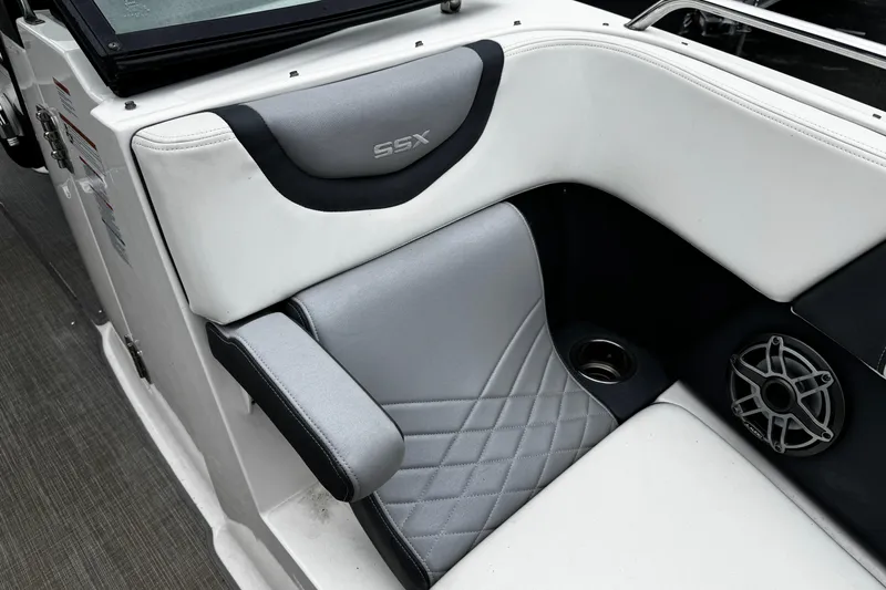 Slide: The Image of 2020 Chaparral 277 SSX boat interior with gray and white seating, speaker, and cup holder. - 41