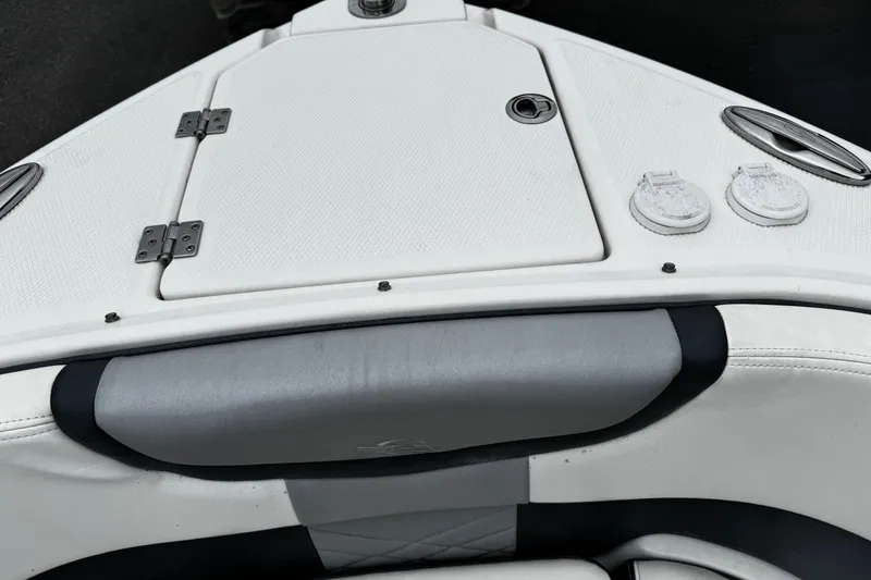Slide: The Image of 2020 Chaparral 277 SSX boat interior, featuring white seating and storage compartments. - 43