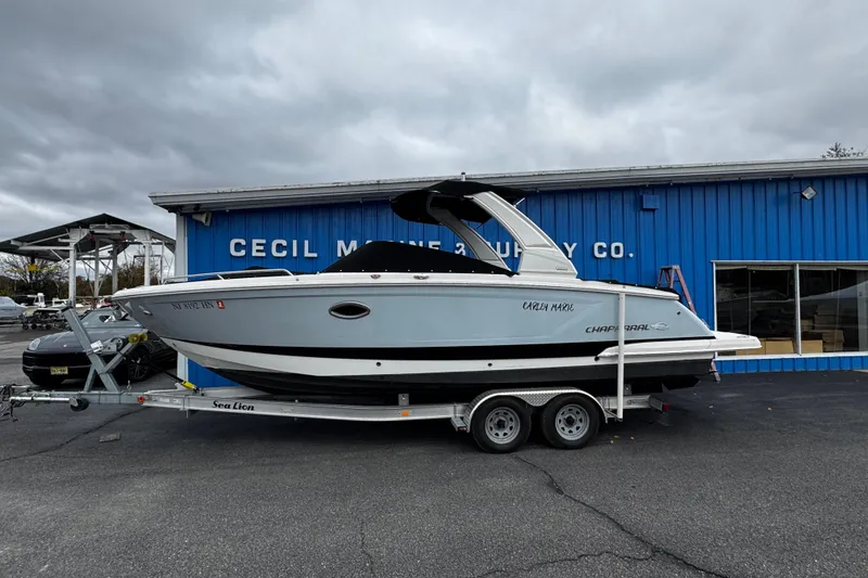 Slide: The Image of 2020 Chaparral 277 SSX boat on trailer outside dealership under cloudy sky. - 5