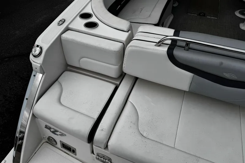 Slide: The Image of 2020 Chaparral 277 SSX boat interior with white seating and cup holders. - 8