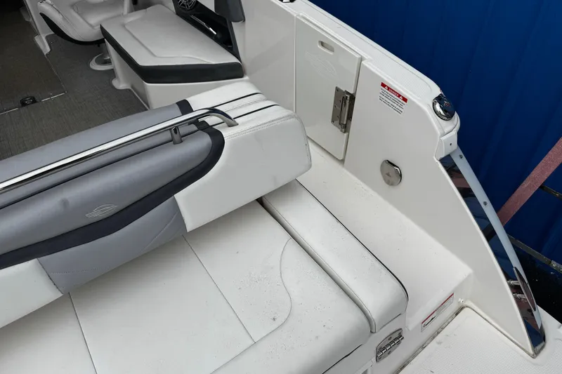 Slide: The Image of 2020 Chaparral 277 SSX boat interior with white and gray seating, sleek design. - 9