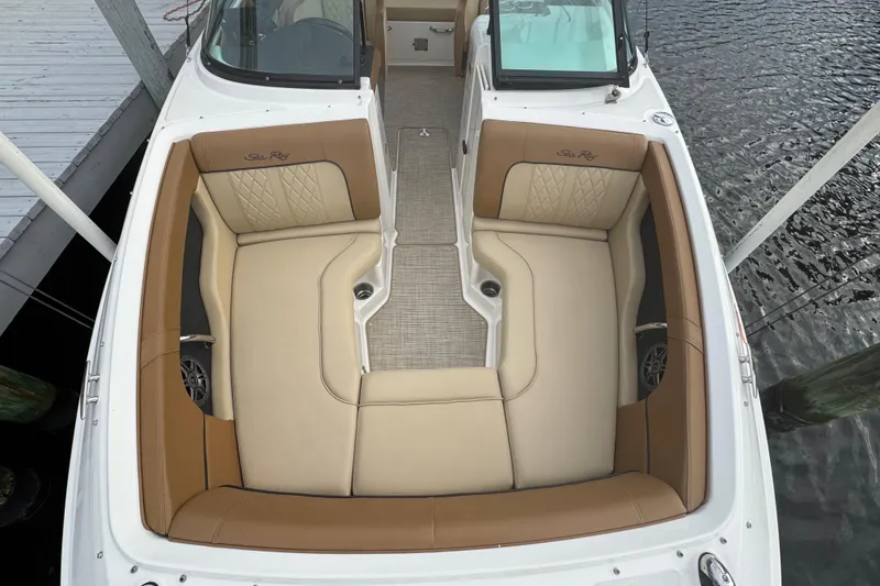 Slide: The Image of 2015 Sea Ray 220 Sundeck Outboard boat interior with tan seating and open deck view. - 30