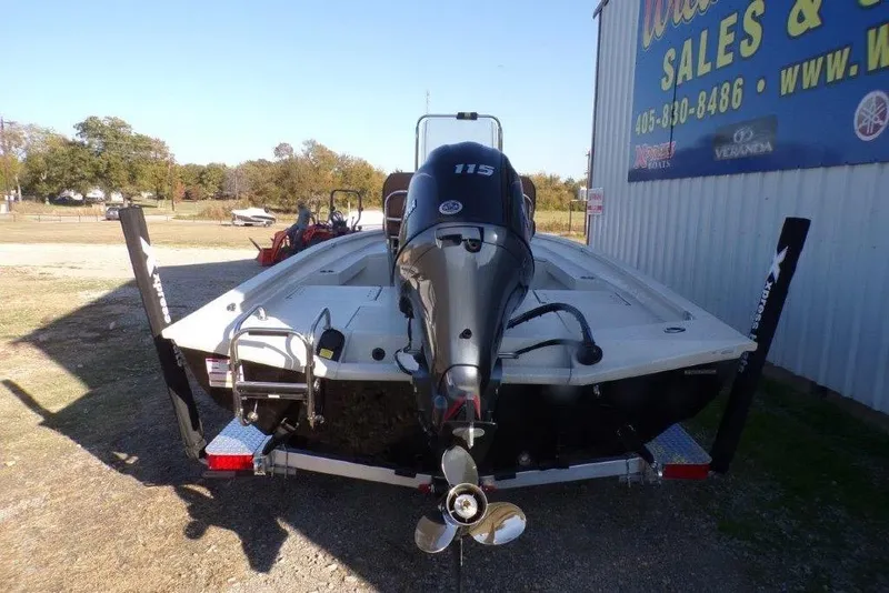 Slide: The Image of 2026 Xpress H20B Bay boat with 115 horsepower engine, parked outdoors. - 1