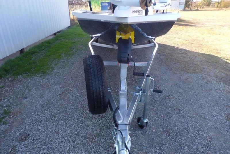 Slide: The Image of 2026 Xpress H20B Bay boat on trailer, parked on gravel. - 10