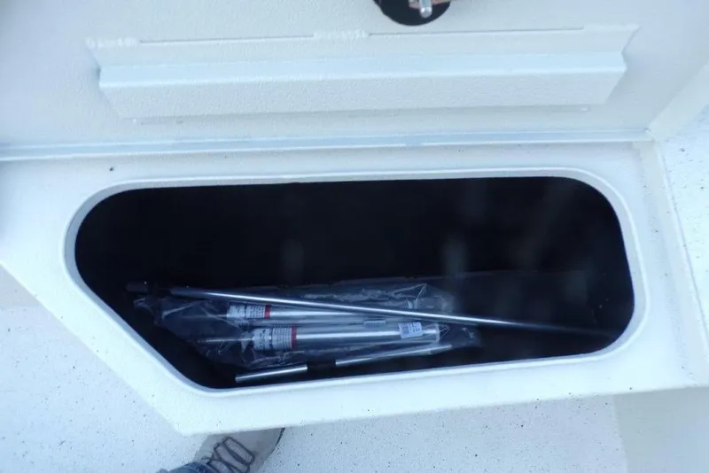 Slide: The Image of Storage compartment of 2026 Xpress H20B Bay boat with metal rods inside. - 16