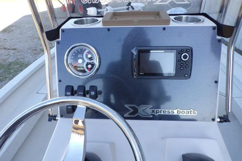 Slide: The Image of 2026 Xpress H20B Bay boat dashboard with steering wheel and navigation system. - 20