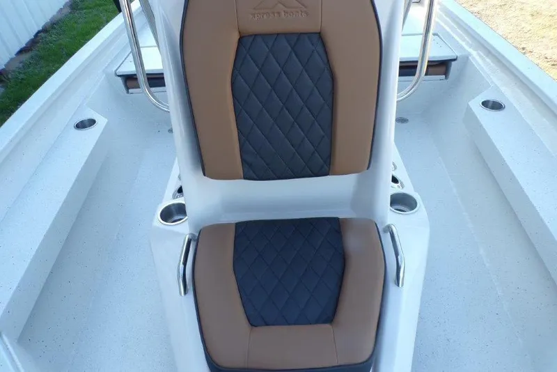 Slide: The Image of 2026 Xpress H20B Bay boat interior with brown and black cushioned seating. - 21