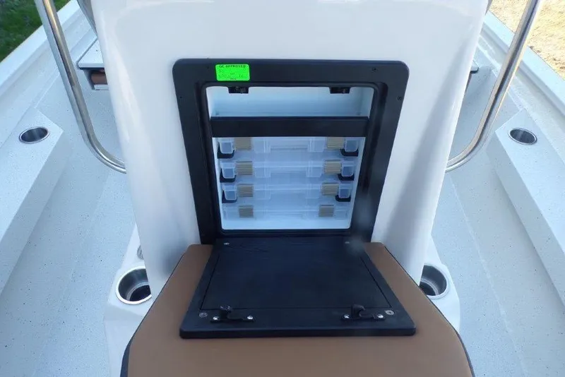 Slide: The Image of 2026 Xpress H20B Bay boat storage compartment with organized tackle boxes. - 22