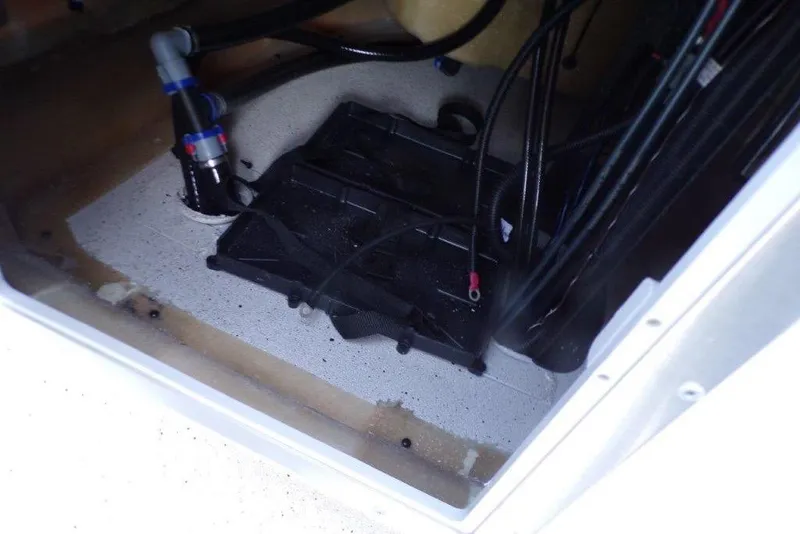 Slide: The Image of Interior view of 2026 Xpress H20B Bay boat compartment with wiring and plumbing. - 24
