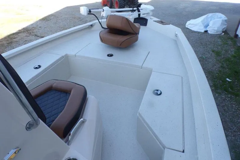 Slide: The Image of 2026 Xpress H20B Bay boat interior with brown seating and storage compartments. - 26