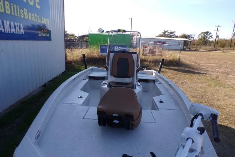 Slide: The Image of 2026 Xpress H20B Bay boat with seating and storage, parked outdoors. - 9