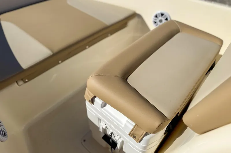 Slide: The Image of 2026 Scout 175 Sportfish interior with beige seating and storage compartment. - 10