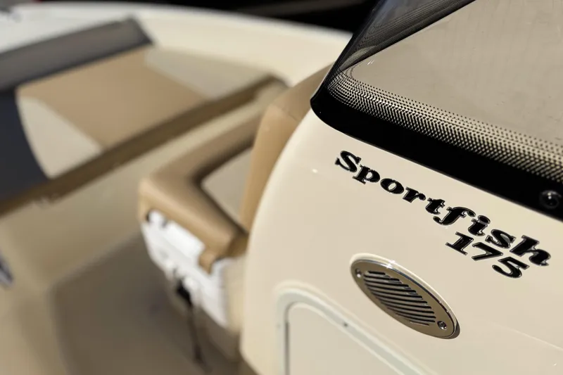 Slide: The Image of 2026 Scout 175 Sportfish boat interior with beige seating and model branding. - 12