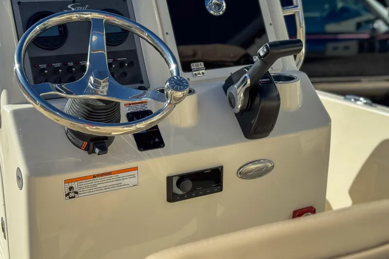 Slide: The Image of 2026 Scout 175 Sportfish boat console with steering wheel and controls. - 21