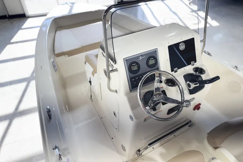 Slide: The Image of 2026 Scout 175 Sportfish boat interior with steering console and seating. - 22