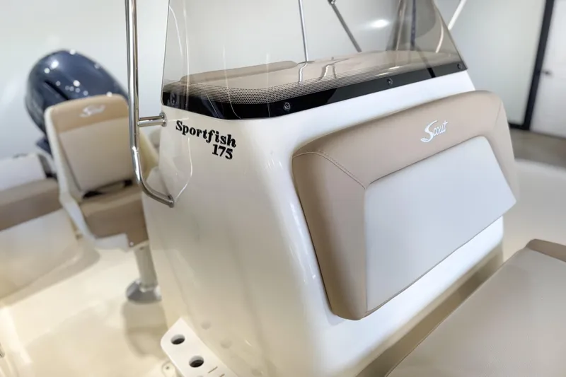 Slide: The Image of 2026 Scout 175 Sportfish boat interior with beige seating and console details. - 24