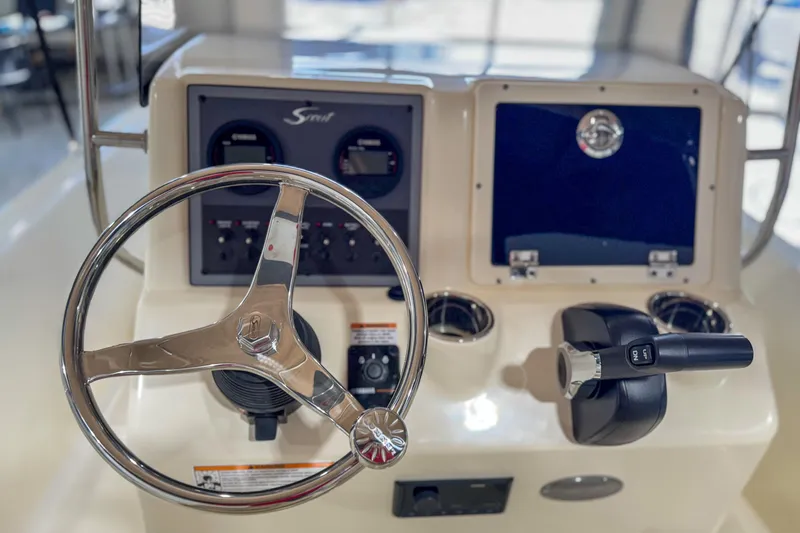 Slide: The Image of Steering console of 2026 Scout 175 Sportfish boat with controls and gauges. - 27