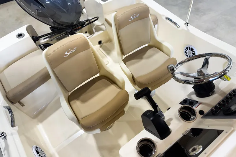 Slide: The Image of 2026 Scout 175 Sportfish boat interior with steering wheel and beige seats. - 28