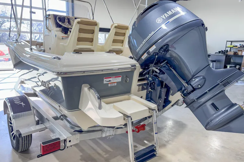 Slide: The Image of 2026 Scout 175 Sportfish boat with Yamaha outboard motor on trailer in showroom. - 8