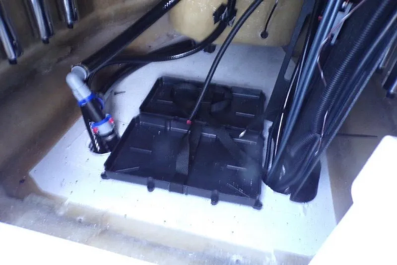 Slide: The Image of 2026 Xpress H20B Bay boat interior wiring and battery compartment. - 13