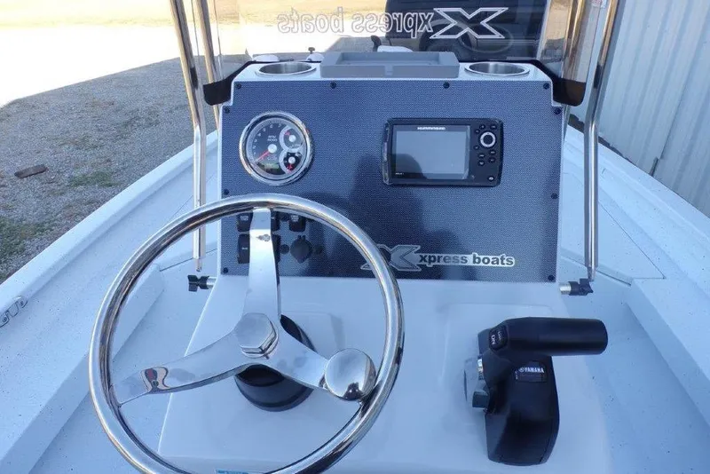 Slide: The Image of 2026 Xpress H20B Bay boat dashboard with steering wheel and navigation system. - 15